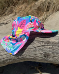Club Tropicana tropical print legionnaire swim hat with neck flap, worn at the beach – bright UPF50+ kids & baby sun hat by Cucumber Cool