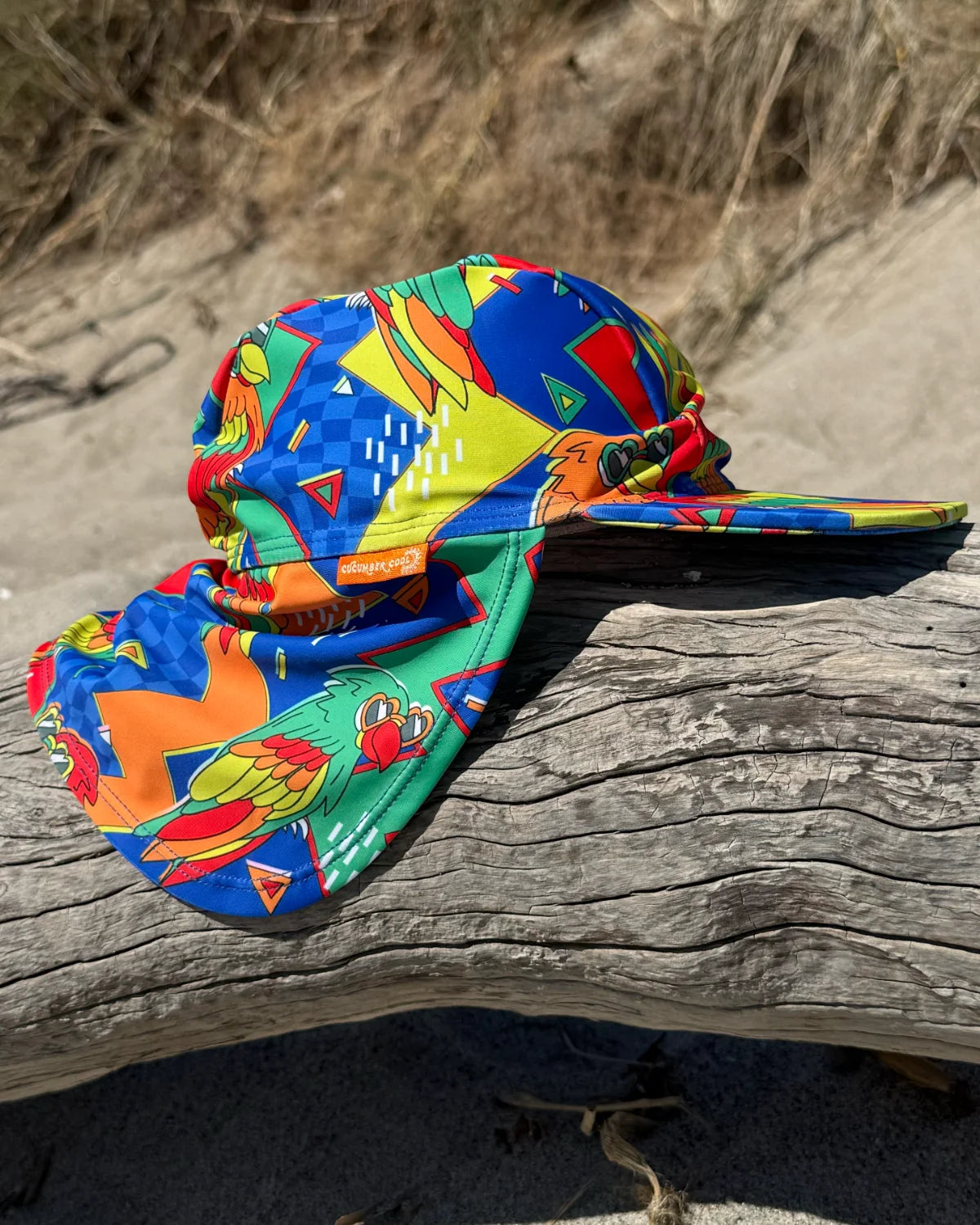 Polly Pizazz legionnaire swim hat with neck flap, worn at the beach – bright UPF50+ kids & baby sun hat by Cucumber Cool