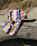 Snazzy Stripes striped legionnaire swim hat with neck flap, worn at the beach – bright UPF50+ kids & baby sun hat by Cucumber Cool