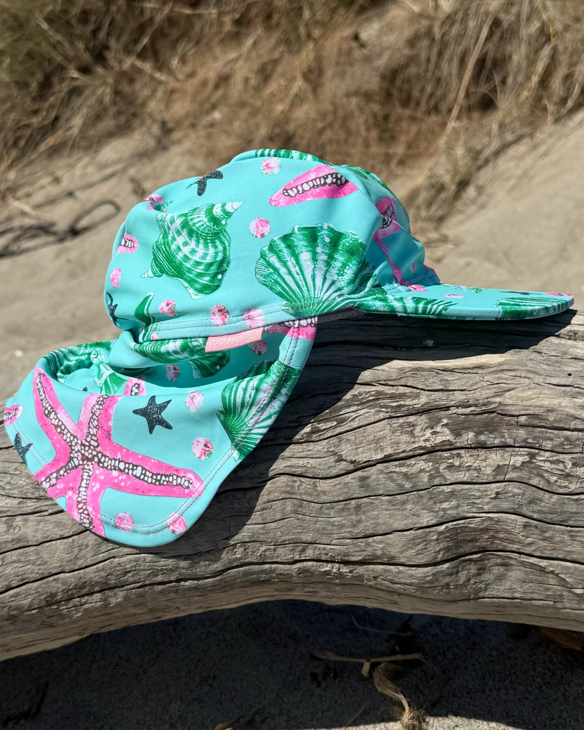 Starfish legionnaire swim hat with neck flap, worn at the beach – bright UPF50+ kids & baby sun hat by Cucumber Cool