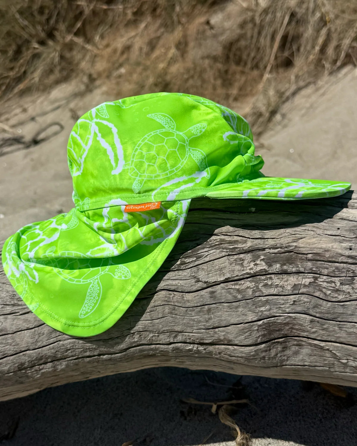 Turtle-Tastic legionnaire swim hat with neck flap, worn at the beach – bright UPF50+ kids & baby sun hat by Cucumber Cool