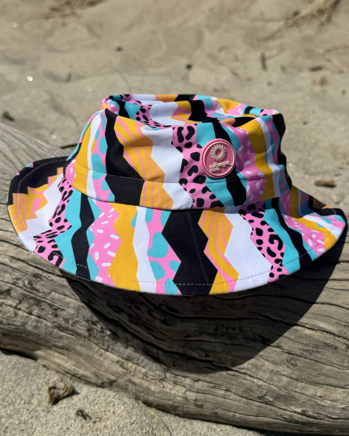 Snazzy Stripes striped kids swim bucket hat with chin strap, worn at the beach – bright UPF50+ round brim beach hat by Cucumber Cool