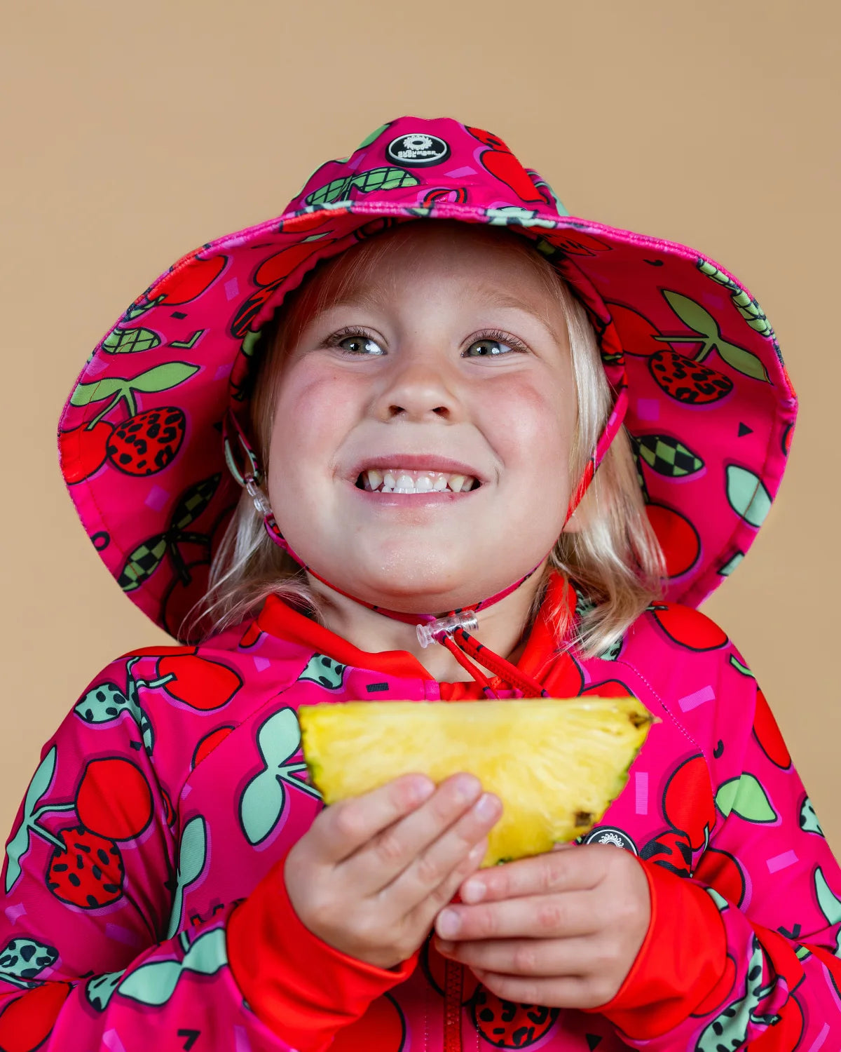 Cherry Pop kids swim bucket hat with chin strap – bright UPF50+ round brim beach hat by Cucumber Cool