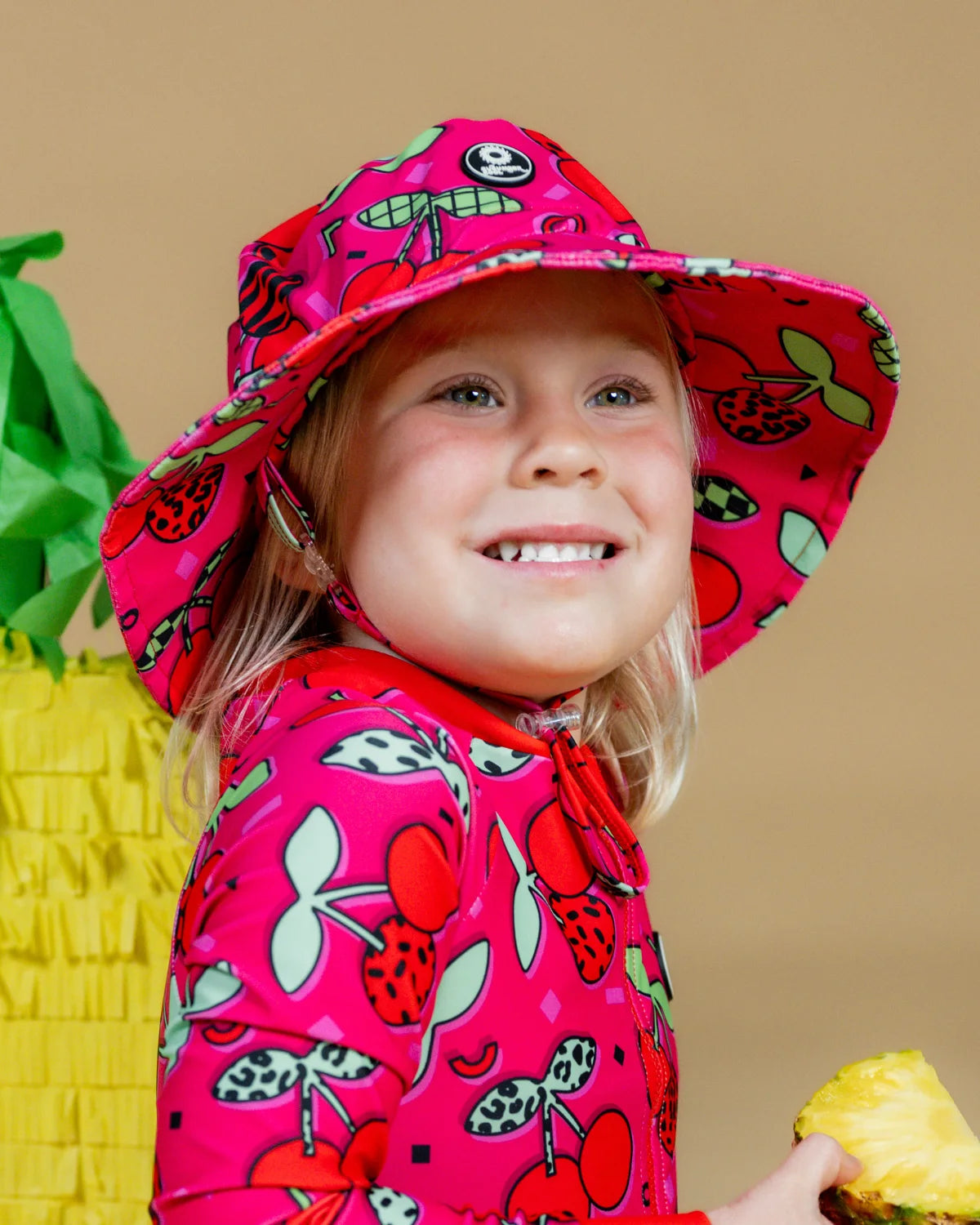 Cherry Pop kids swim bucket hat with chin strap, photo 2 – bright UPF50+ round brim beach hat by Cucumber Cool