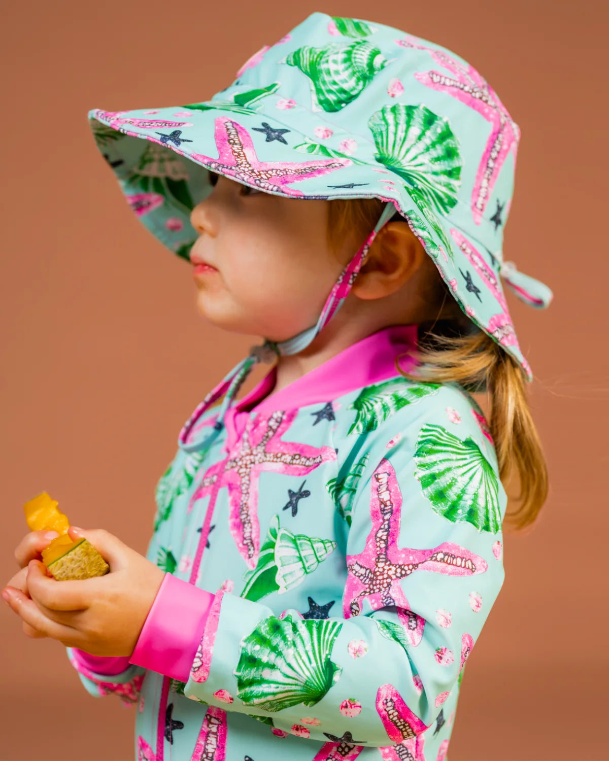 Starfish toddler sunsuit, photo 3 – bright UPF50+ long sleeve swimsuit by Cucumber Cool
