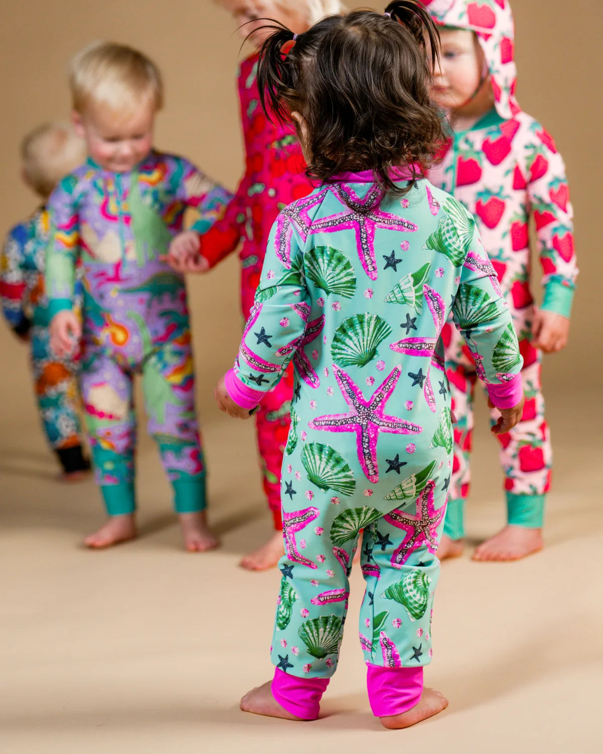 Starfish toddler sunsuit, photo 2 – bright UPF50+ long sleeve swimsuit by Cucumber Cool