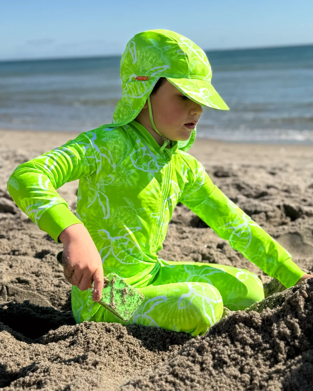 Turtle-Tastic turtle print kids sunsuit, photo 3 – bright UPF50+ long sleeve full coverage swimsuit by Cucumber Cool