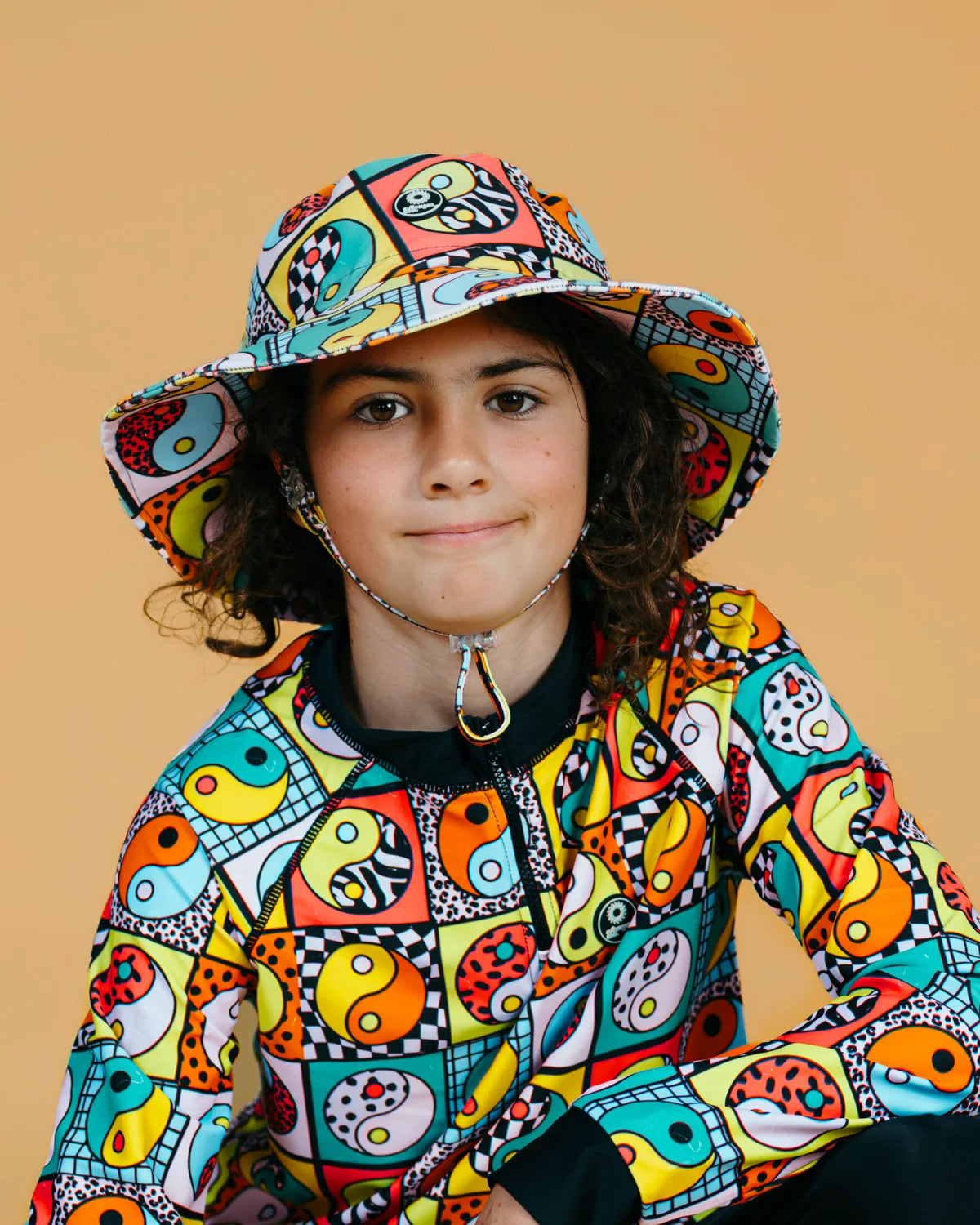 Yin Yang Yeah! kids swim bucket hat with chin strap, photo 2 – bright UPF50+ round brim beach hat by Cucumber Cool