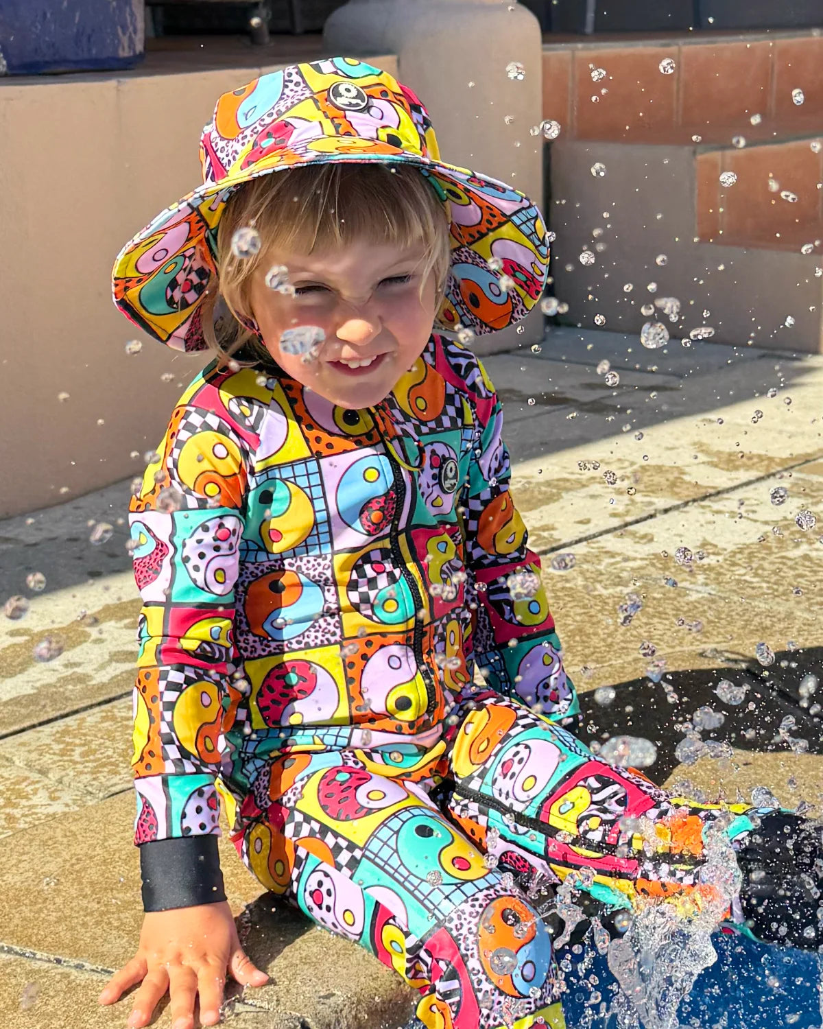 Yin Yang Yeah! toddler sunsuit, photo 3 – bright UPF50+ long sleeve swimsuit by Cucumber Cool