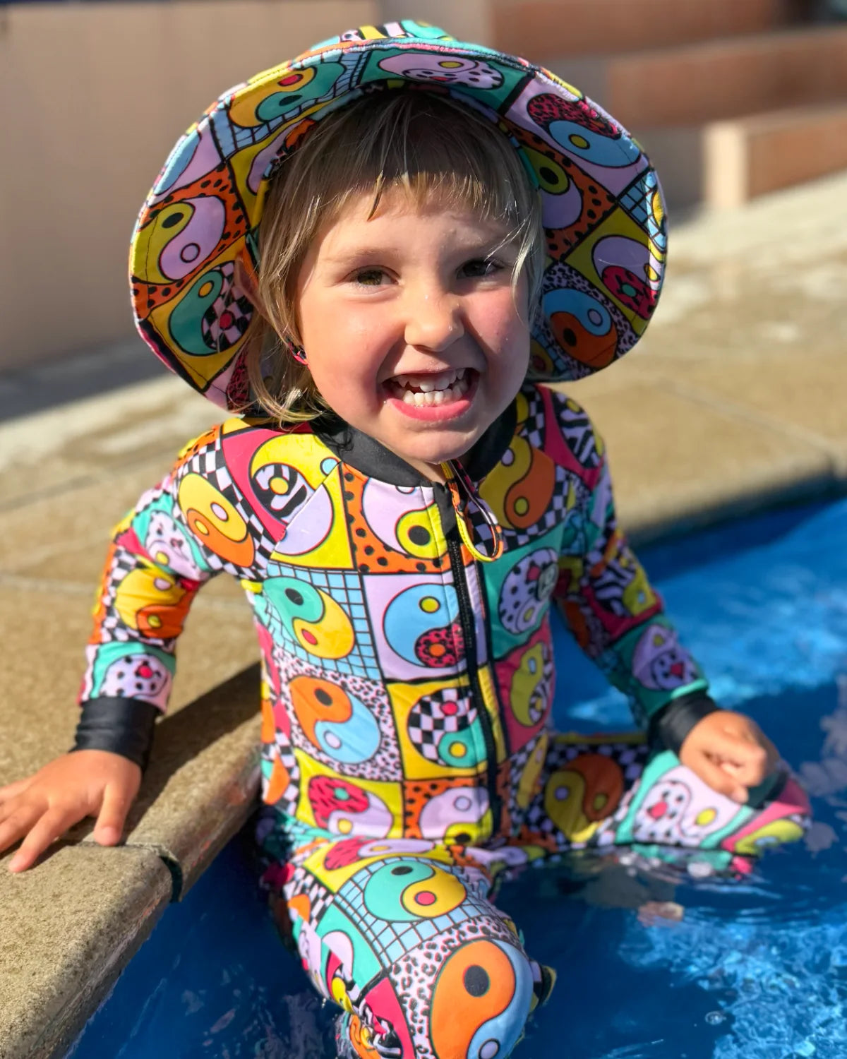 Yin Yang Yeah! toddler sunsuit, photo 2 – bright UPF50+ long sleeve swimsuit by Cucumber Cool