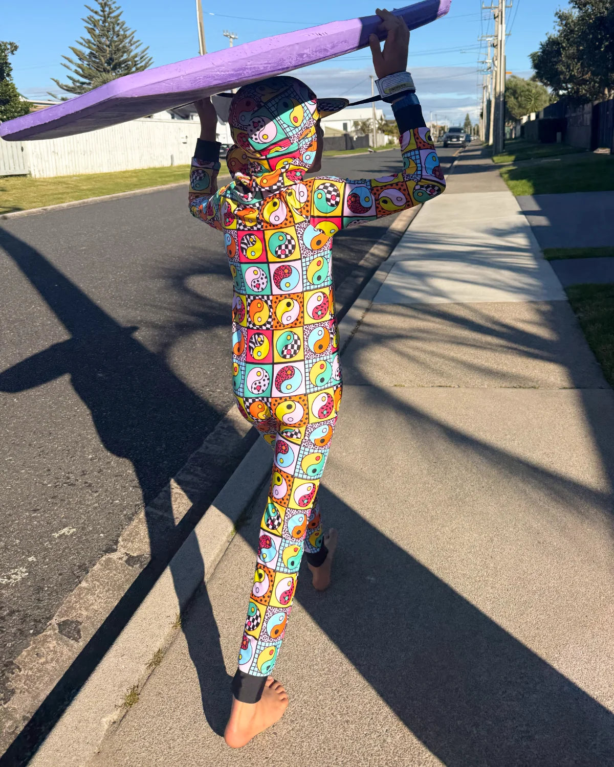 Yin Yang Yeah! kids sunsuit, photo 2 – bright UPF50+ long sleeve full coverage swimsuit by Cucumber Cool