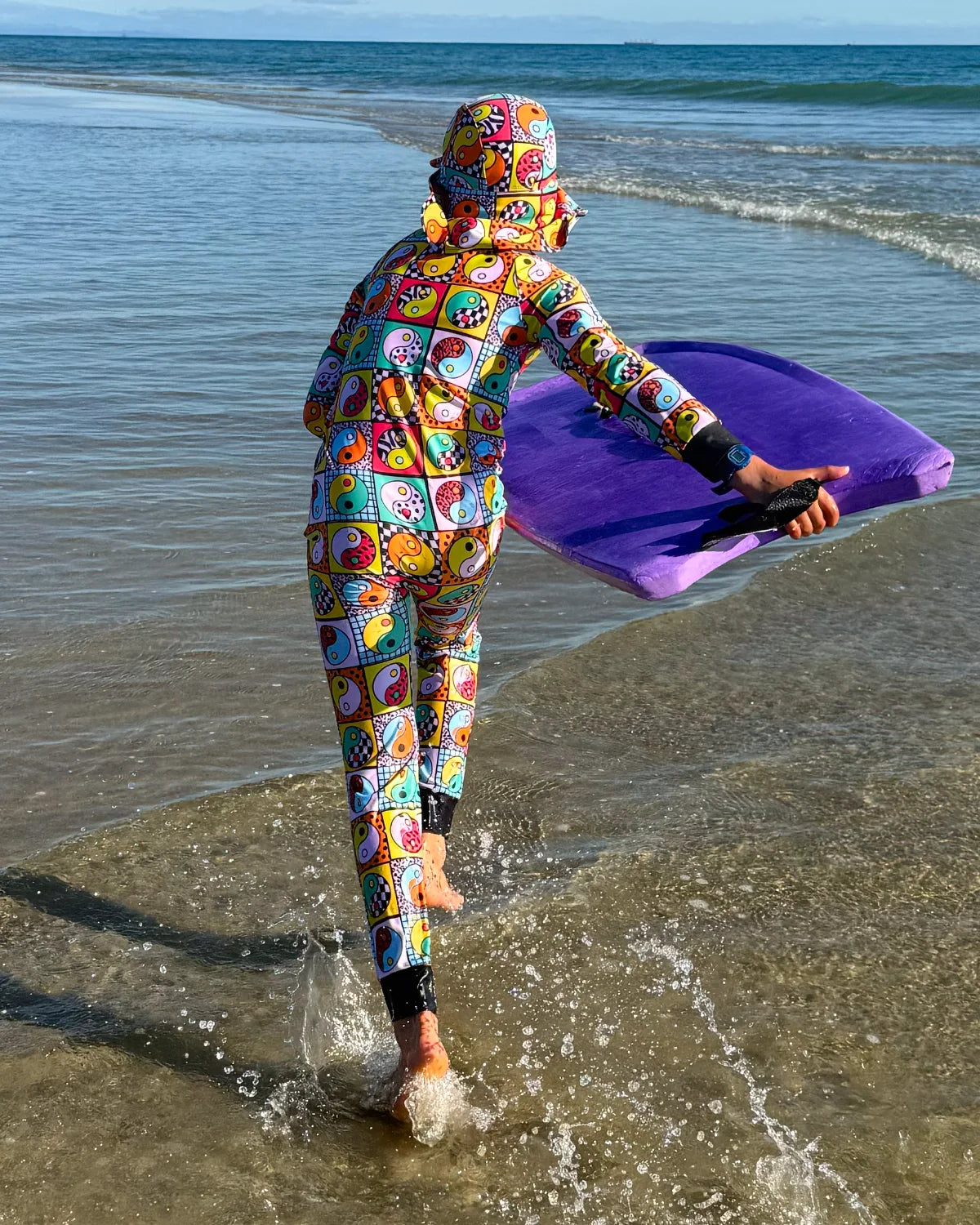 Yin Yang Yeah! kids sunsuit, photo 3 – bright UPF50+ long sleeve full coverage swimsuit by Cucumber Cool
